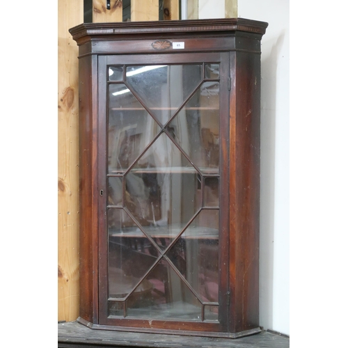 65 - An early 20th century mahogany astragal glazed hanging corner cabinet, 105cm high x 70cm wide 