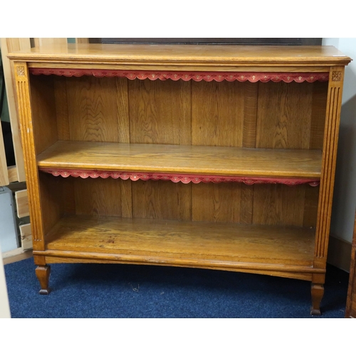 66 - An early 20th century two tier open bookcase on shaped tapering supports, 96cm high x 116cm wide x 3... 