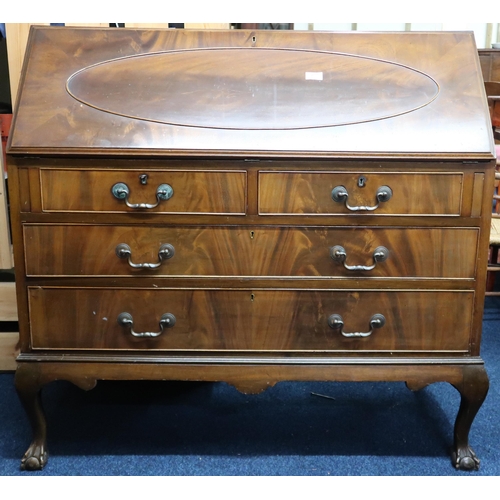 69 - An early 20th century mahogany writing bureau with fall front writing compartment over two short and... 