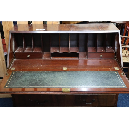 69 - An early 20th century mahogany writing bureau with fall front writing compartment over two short and... 