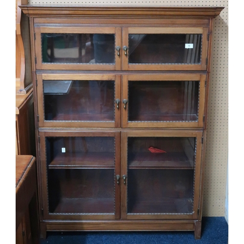 70 - A 20th century mahogany glazed bookcase with three pairs of graduating glazed doors on square feet,1... 