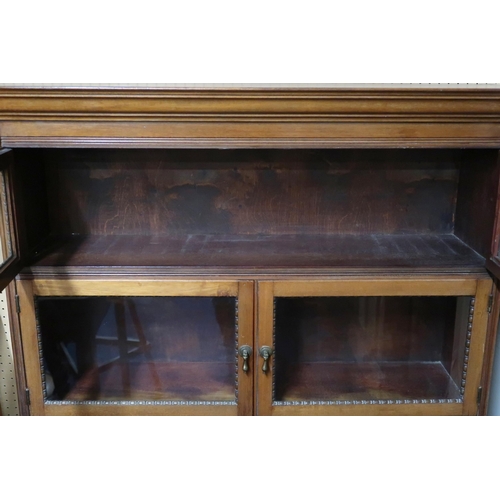 70 - A 20th century mahogany glazed bookcase with three pairs of graduating glazed doors on square feet,1... 