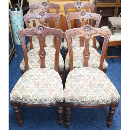 76 - A set of six Victorian walnut framed dining chairs with tapestry upholstered seats on turned support... 