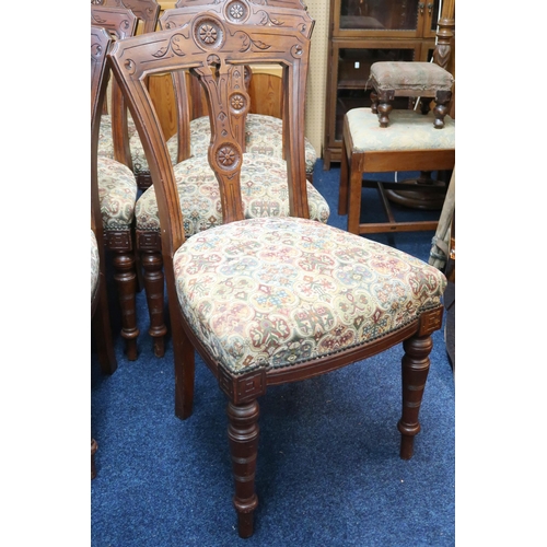 76 - A set of six Victorian walnut framed dining chairs with tapestry upholstered seats on turned support... 