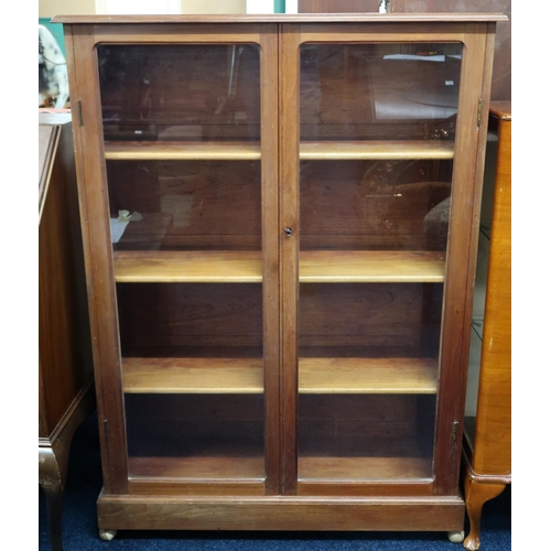 77 - An early 20th century mahogany glazed two door bookcase on plinth base, 126cm high x 90cm wide x 28c... 