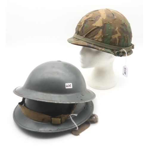 408 - Two WW2 British Brodie helmets, one dated 1940 (the lining of the upper helmet has adhered to the cr... 