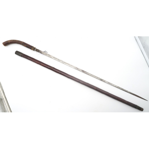 420 - A sword stick, the concealed blade approx. 68cm in length; together with a Spanish riding crop conce... 