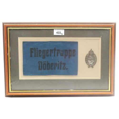 422 - A WW1 Imperial German Prussian pilot's badge, mounted in a glazed frame alongside an armband printed... 