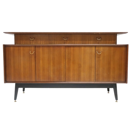 2108A - A MID 20TH CENTURY G PLAN E-GOMME LIBRENZA DINING SUITEComprising Tola sideboard with three short dr... 