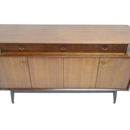 2108A - A MID 20TH CENTURY G PLAN E-GOMME LIBRENZA DINING SUITEComprising Tola sideboard with three short dr... 