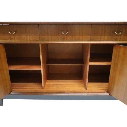 2108A - A MID 20TH CENTURY G PLAN E-GOMME LIBRENZA DINING SUITEComprising Tola sideboard with three short dr... 