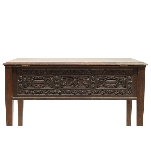 2007A - A 19TH CENTURY OAK SIDE TABLEWith rectangular hinged top over carved friezes on square tapering supp... 