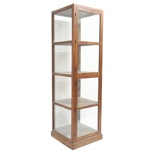 2013B - A 20th CENTURY TEAK FRAMED HABERDASHERY STYLE SHOPS DISPLAY CABINETWith two glazed doors enclosing f... 