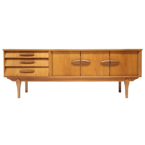 2105A - A MID 20TH CENTURY TEAK JENTIQUE SIDEBOARDWith fall front drinks cabinet flanked by cabinet doors al... 