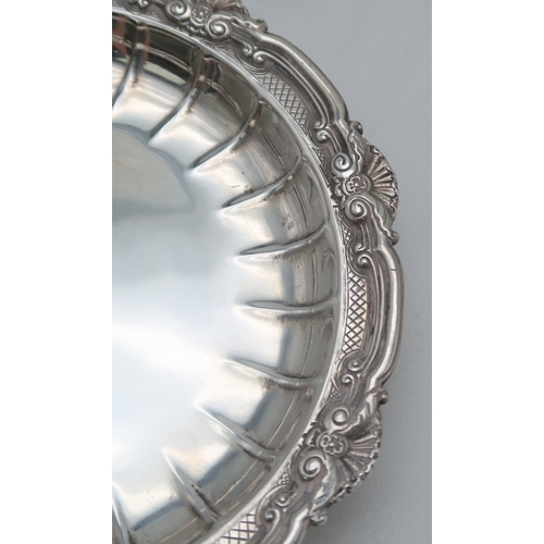 2507 - A SET OF FOUR GEORGE V SILVER DISHESby Crichton Brothers, London 1930, of circular form, with cast s... 