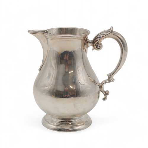 2512 - A GEORGE V SILVER CREAM JUGby Heming & Co Ltd, London 1924, of baluster form, with an acanthus-c... 