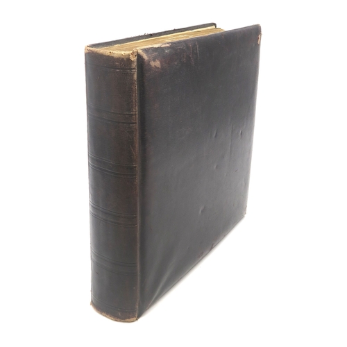 2633 - A SUBSTANTIAL LEATHER-BOUND POSTCARD ALBUMEarly-20th century, containing approximately 750 postcards... 