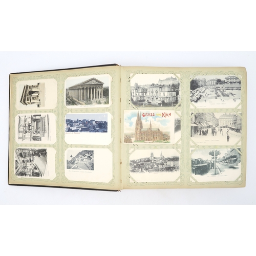 2633 - A SUBSTANTIAL LEATHER-BOUND POSTCARD ALBUMEarly-20th century, containing approximately 750 postcards... 