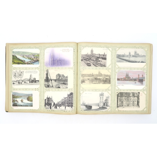 2633 - A SUBSTANTIAL LEATHER-BOUND POSTCARD ALBUMEarly-20th century, containing approximately 750 postcards... 