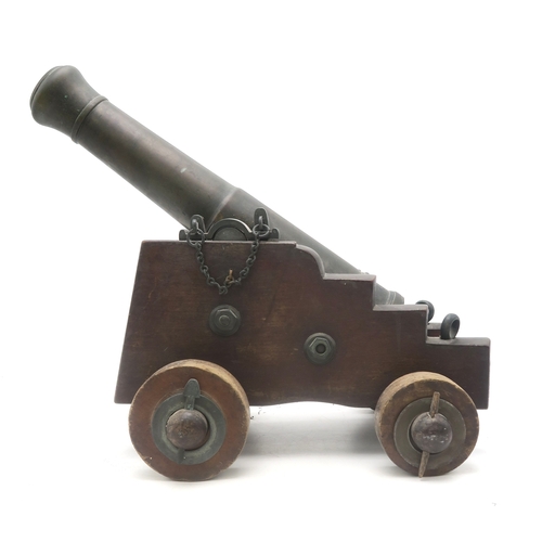 2634 - A BRONZE SIGNAL CANNONMounted upon a hardwood carriage, the barrel measuring approx. 46cm in length,... 