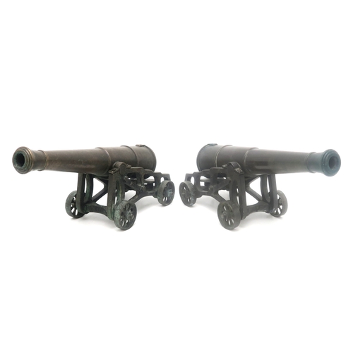 2635 - A PAIR OF MINIATURE BRONZE CANNONSEach with barrel measuring approx. 35cm in length, inclusive of kn... 