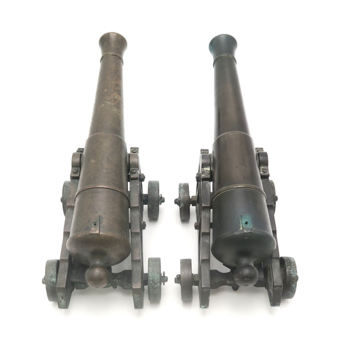 2635 - A PAIR OF MINIATURE BRONZE CANNONSEach with barrel measuring approx. 35cm in length, inclusive of kn... 