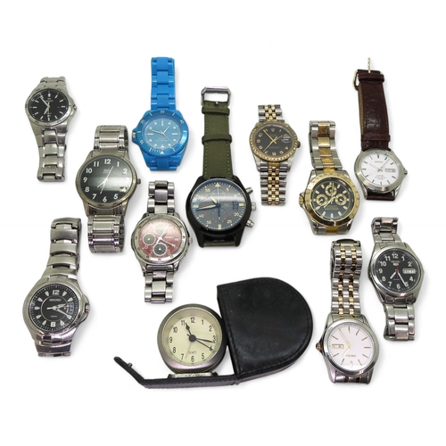 9026 - A collection of fashion watches (11) and a traveling alarm clock. Please note, this lot is sold as s... 