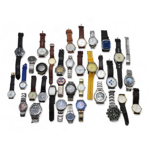 9028 - A large collection of fashion watches Please note, this lot is sold as seen, it contains replicas.