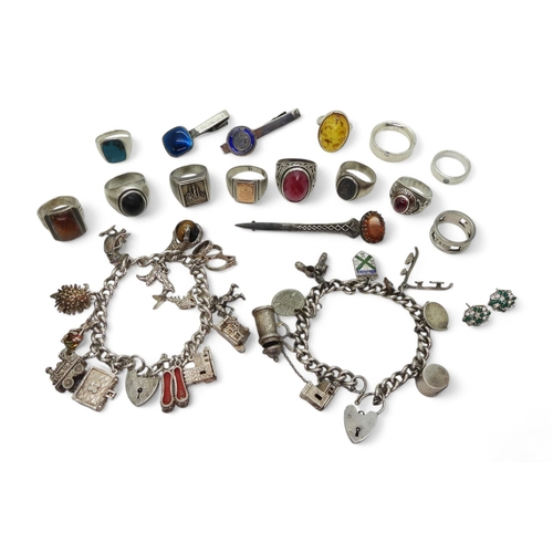 9031 - A Robert Allison brooch, set with a glass gem, two silver and white metal charm bracelets to include... 