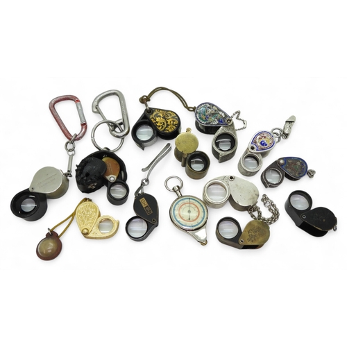 9035 - Twelve jewellers loopes, some in white metal and enamel, one with attached fertility symbol, and a m... 