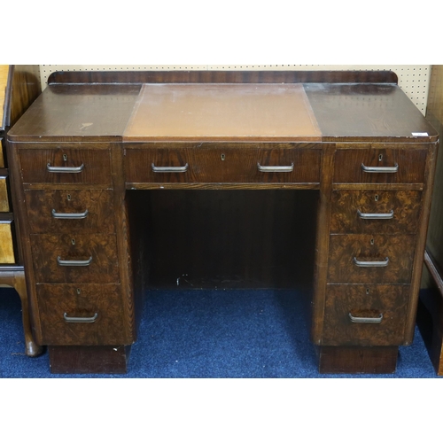 10 - An early 20th century art deco style desk with skiver top over central drawer flanked by four drawer... 