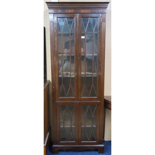 12 - A 20th century mahogany astragal glazed bookcase with dentil cornice over two pairs of glazed doors ... 