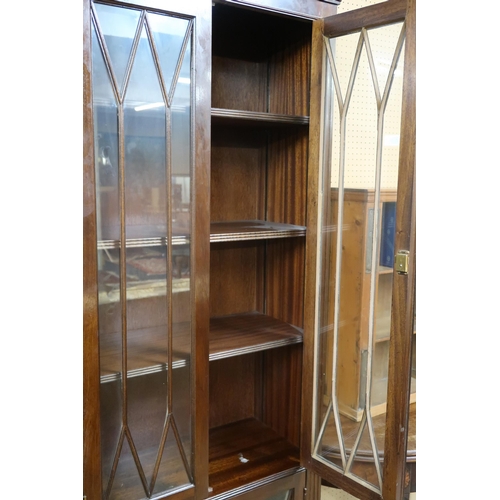 12 - A 20th century mahogany astragal glazed bookcase with dentil cornice over two pairs of glazed doors ... 