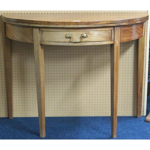 128 - A 19th century mahogany demi lune fold-over tea table with single drawer on square tapering supports... 