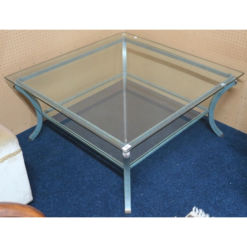 132 - A 20th century glass topped two tier square coffee table with green metallic base, 44cm high x 95cm ... 