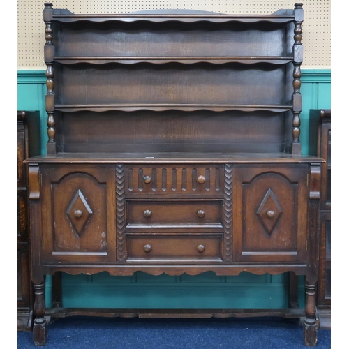 4 - A 20th century Nero stained oak dresser with three tiered plate back on base with three central draw... 