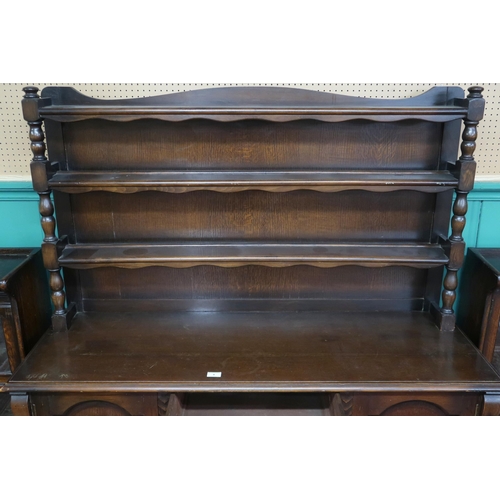 4 - A 20th century Nero stained oak dresser with three tiered plate back on base with three central draw... 