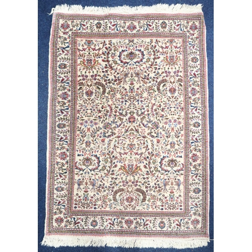 61 - A cream ground Keshan rug with multicoloured floral/foliate patterned ground within floral border, 1... 