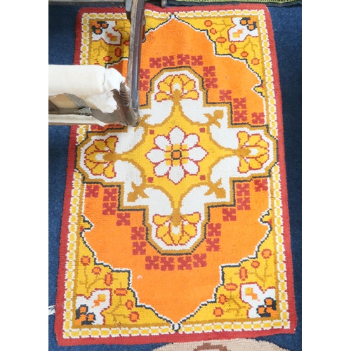 83 - A lot comprising a mid 20th century orange ground rug, 151cm high x 95cm wide, a beige ground half c... 