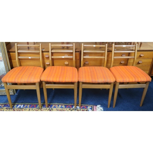 88 - A set of four mid 20th century teak framed Scandart ladderback dining chairs on shaped tapering supp... 