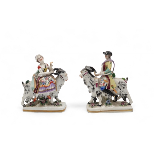 212 - A pair of porcelain figures of Count Bruhl's Tailor and Wife, both modelled seated on the back of go... 