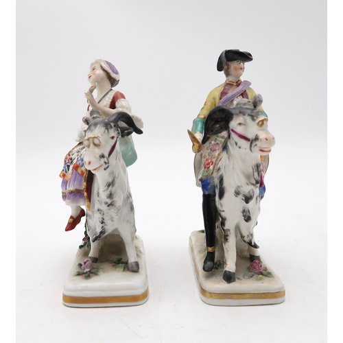 212 - A pair of porcelain figures of Count Bruhl's Tailor and Wife, both modelled seated on the back of go... 