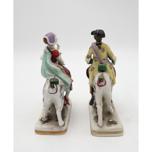 212 - A pair of porcelain figures of Count Bruhl's Tailor and Wife, both modelled seated on the back of go... 