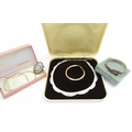 A 9ct gold ribbon chain bracelet 3gms, a silver buckle shaped bangle ...