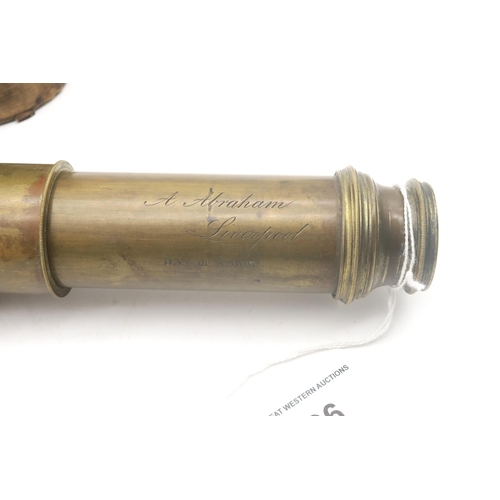 496 - A brass three-draw day or night telescope by A. Abraham of Liverpool, housed in its original leather... 