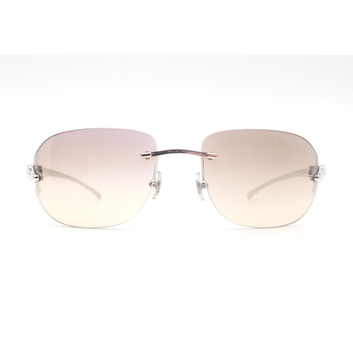 498 - A pair of Cartier sunglasses, with protective case and retaining original packaging 