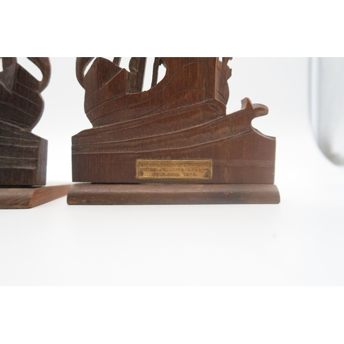 506 - A pair of folding bookends, each carved as a ship in full sail, one with plaque affixed reading 