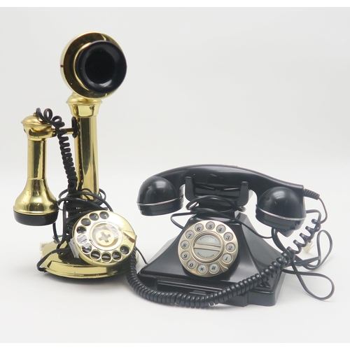 538 - Two reproduction telephones, together with a framed reproduction Bisto advertisement and an L.S. Low... 