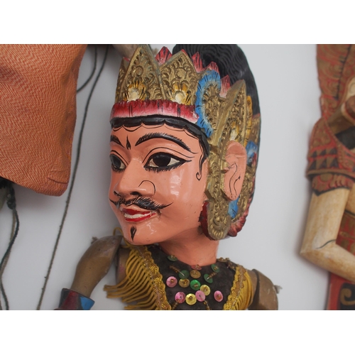 547 - A collection of Indonesian carved and painted string and stick puppets, the largest approx. 61cm in ... 