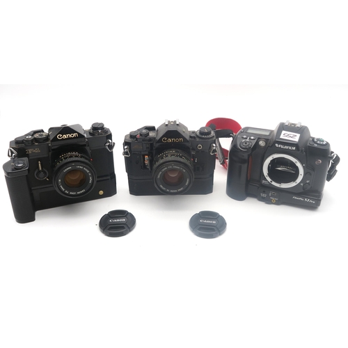 552 - Canon A-1 and F-1 cameras, each fitted with an FD 50mm 1:1.8 lens; Fujifilm Finepix S1 Pro and Nikon... 